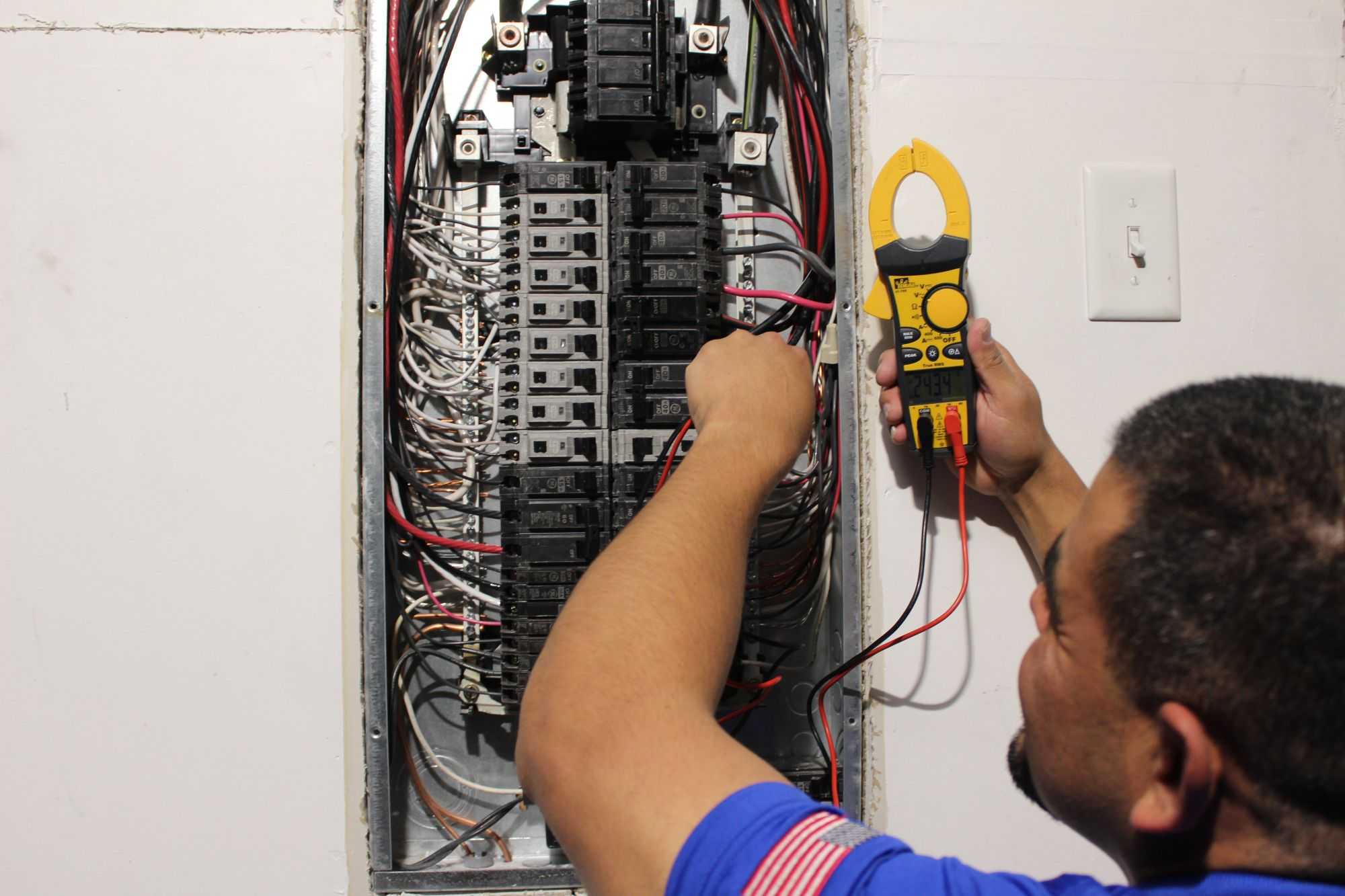 WireNut Licensed Electrician Performing Maintenance on an Electrical Switch Board