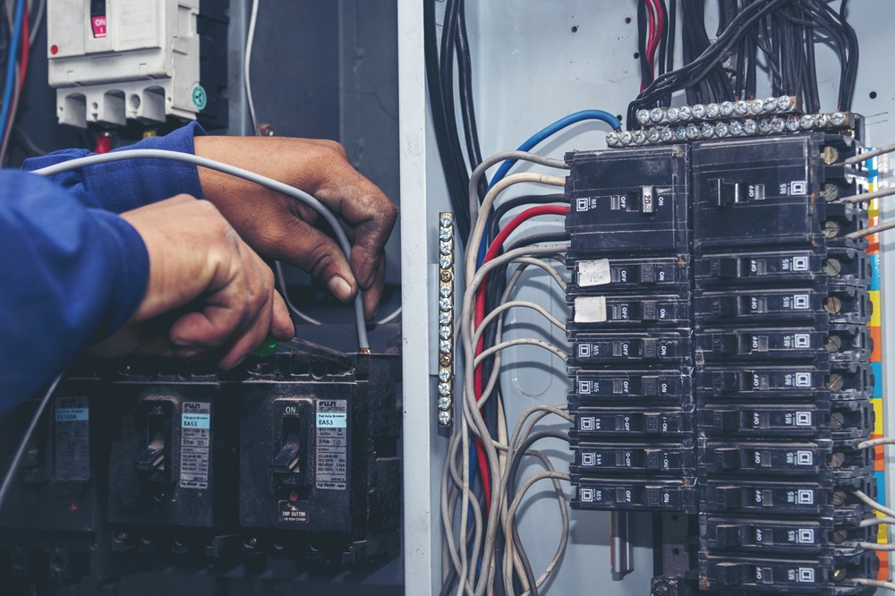 electrician working on electrical panel